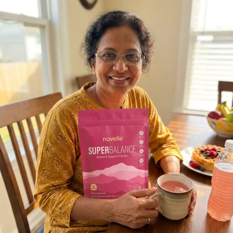 Priya holding SuperBalance at her breakfast table