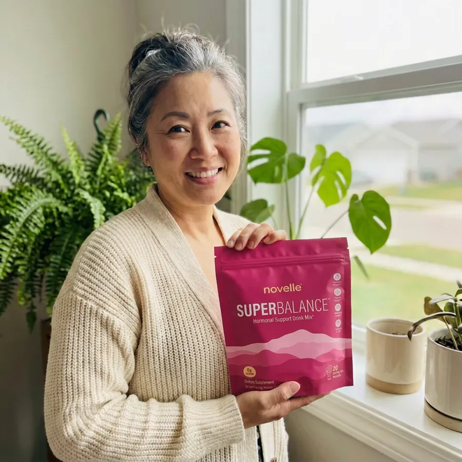 Karen holding a pouch of SuperBalance by her window
